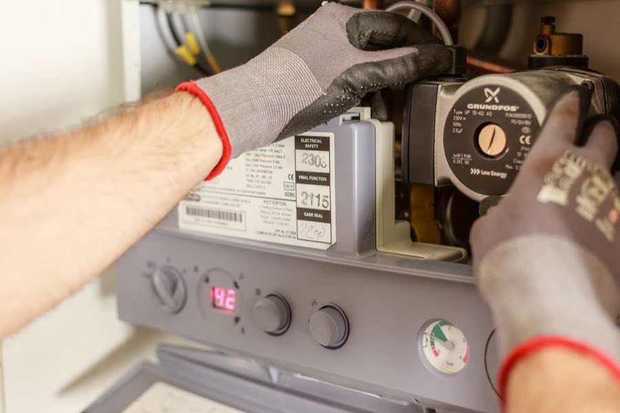 Technician installing a new tank water heater